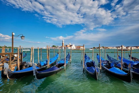 Gondolas and in lagoon of Venice by Saint Mark (San Marco) square with San Giorgio di Maggiore