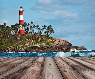 Wood planks floor with old lighthouse and sea waves in background