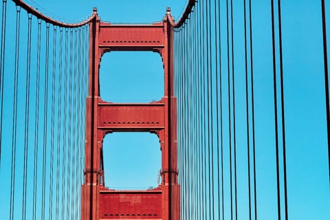 Orange pylon and steel cables of the suspension bridge, detail, Golden Gate Bridge, blue sky, San