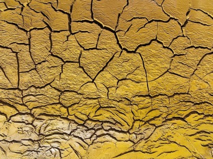 Mineral-rich cracked earth at the bank of the Rio Tinto (Red river), aerial view, drone shot,