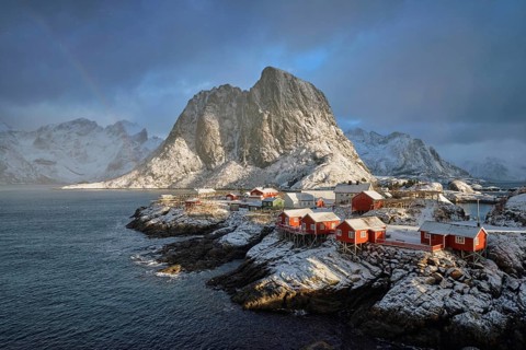 Hamnoy fishing village on Lofoten Islands, Norway with red rorbu houses. With falling snow in