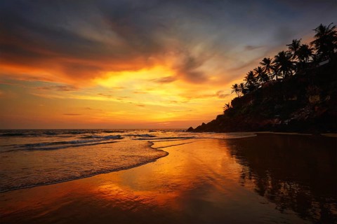 Sunset on Varkala beach popular tourist destination in Kerala state, South India