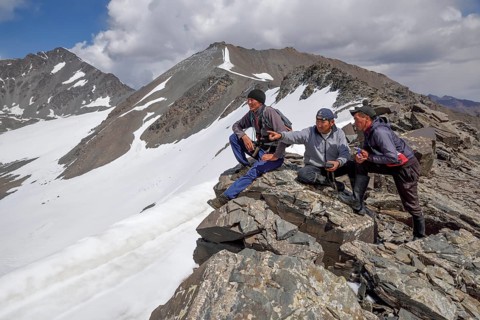 Local hikers on a ridge above the West Karakol Valley, Tian Shan Mountains, Naryn region,