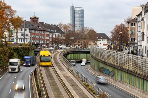 Motorway A40, Ruhrschnellweg, skyline of the city centre of Essen, exit Essen-Huttrop, track bus