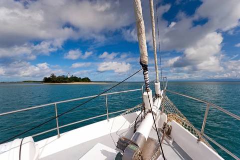 Sailing, sailing ship off uninhabited coral island Low Island near Port Douglas, Barrier reef,