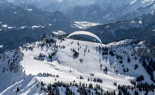 Mountains in winter, paraglider with skis on Sonntagshorn, Chiemgau Alps, Bavaria, Germany, Europe