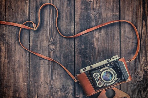 Photography concept background, old retro vintage camera on grunge wooden texture
