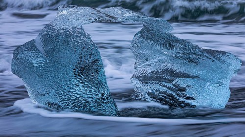 Artfully shaped iceberg on the black beach of Breidamerkursandur, near Jökullsarlon, Sudurland,