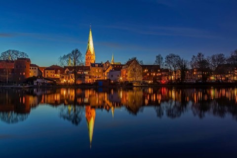 Houses and St. -Aegidien-Kirche, Aegidienkirche reflected in water at Krähenteich in the old city