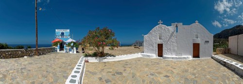 Café Skopi with small white church Parekkl?sia under a blue sky with a quiet Mediterranean