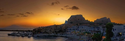 Harbour of the fishing village Finiki at dusk with boats and rocks, fishing village Finiki,