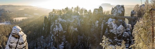 Panorama of Neurathen Castle and the Bastei Bridge on a winter morning, in the background the