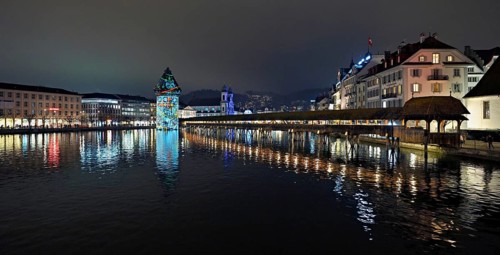 Wassertum with light installation, Chapel Bridge on the right, Jesuit Church on the Reuss at dusk