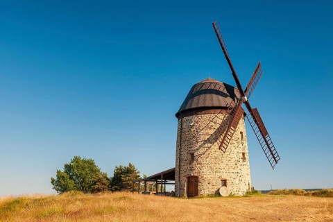The tower windmill of Warnstedt in the evening light under a blue sky, Teufelsmühle, Thale,