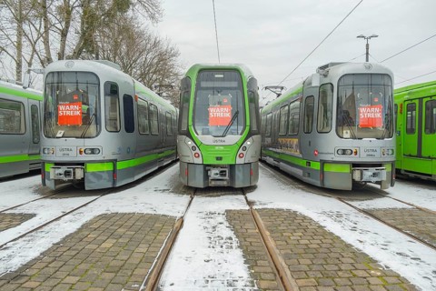 View of a TW 3000 and TW 2000 train of the Üstra with a strike poster stuck to the windscreen,