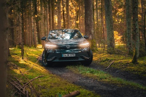 Car driving along a wooded path in a warm autumn atmosphere, car sharing vehicle Deer Mobility,