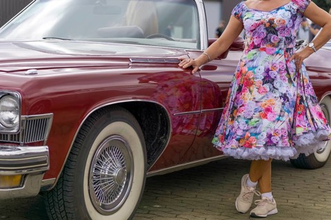 Vintage American road cruiser Buick with woman and petticoat