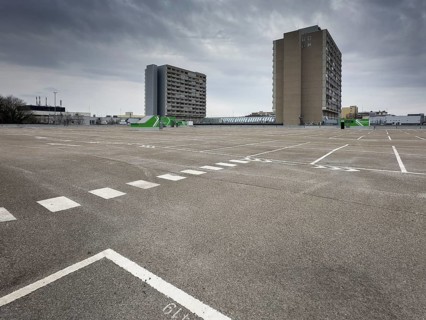 Symbolic image economic crisis, dark clouds in the sky, empty parking deck at