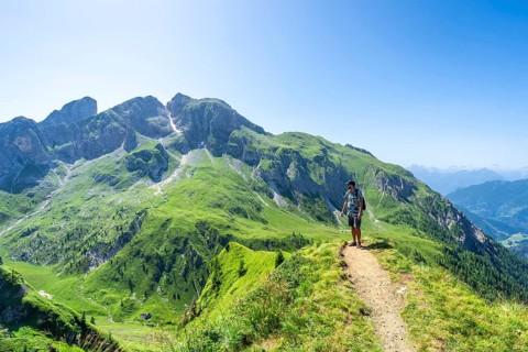 Tourist enjoying breathtaking scenery while hiking on the giau pass, surrounded by the stunning