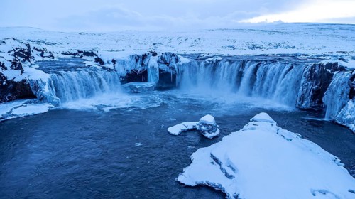 Amazing scenery of frozen Godafoss waterfall at sunset in winter, Iceland, Europe