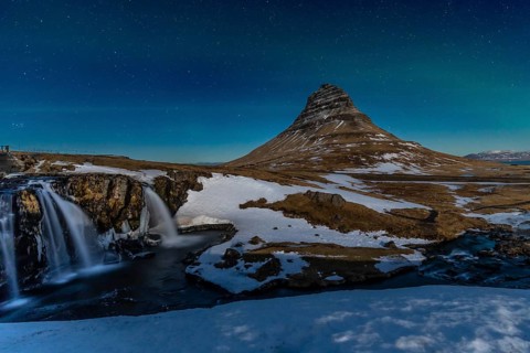 Long exposure on the picturesque Kirkjufell mountain at night in winter in Iceland