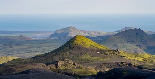 Volcanic mountain landscape overgrown with moss, atmospheric mountain landscape in the evening