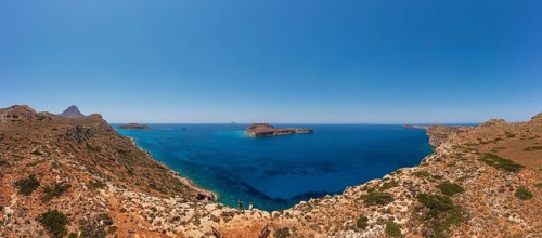 Hikers on the way to the cape of the Gramvousa peninsula with a view of the island of Imeri
