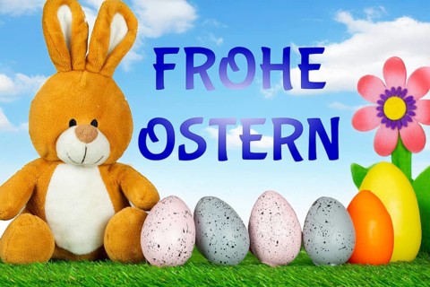 Easter greetings: Easter bunny with colourful Easter eggs with text FROHE OSTERN (Composing)