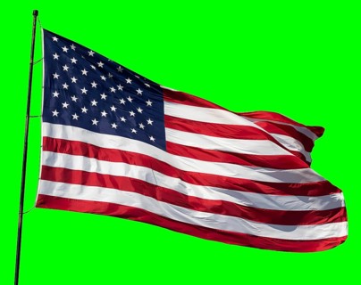 American flag waving in the wind on a flag pole over a green screen