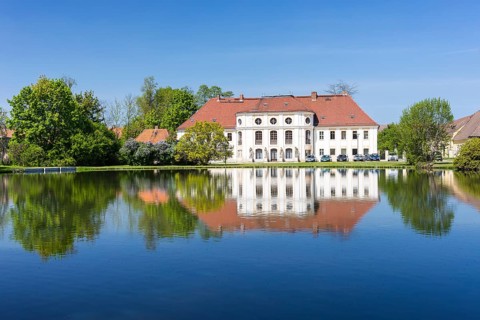 Baroque castle with reflection in the large pond, Königswartha, Upper Lusatia, Saxony, Germany,