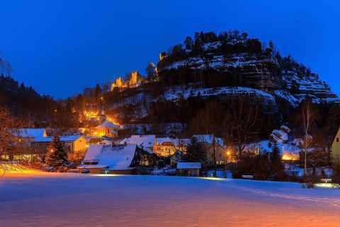 View of Oybin Mountain with ruins and village with mountain church in the snow, Oybin, Zittau