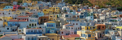 Panorama of the village of Menetes with densely built pastel-coloured houses on a Mediterranean