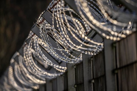 Symbolic image security, S-wire rolls, NATO wire, on a fence top, demarcation of a property,