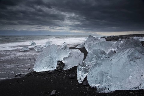 Little icebergs and crushed ice on the black beach at Joekulsarlon glacial lake