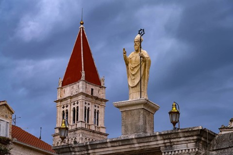 Statue of the patron saint Ivan Ursini on the city gate and the tower of the Cathedral of St