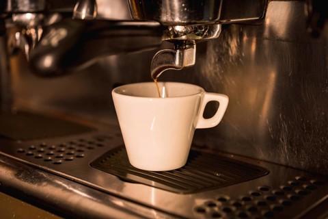 Coffee machine putting a decaf in a white cup
