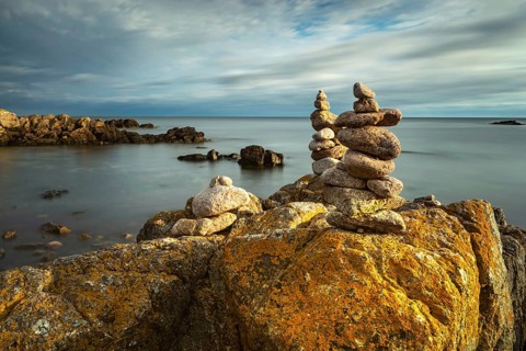 Rocky coast with cairns in the morning light, Allinge-Sandvig, Bornholm, Denmark, Europe