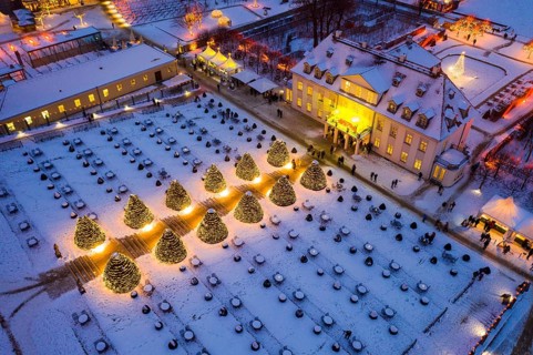 Aerial view of Wackerbarth Castle with castle park in snow and Christmas lights, Radebeul, Saxony,