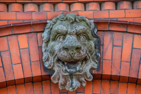 Lion head in concrete on decorative brick wall in Ystad, Skåne County, Sweden, Scandinavia, Europe