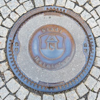 Manhole cover with coat of arms of Hainichen, Saxony, Germany, Europe