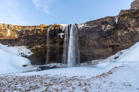 Beautiful Seljalandsfoss waterfall with snow in winter in Iceland