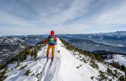 Ski tourer at the summit of Simetsberg, mountain panorama, Estergebirge, Bavarian Prealps, Bavaria