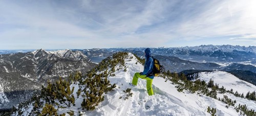 Ski tourer at the summit of Simetsberg, mountain panorama, Estergebirge, Bavarian Prealps, Bavaria