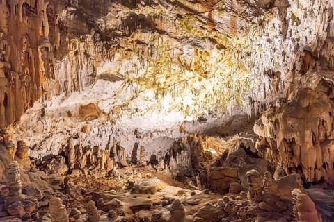 Breathtaking view of illuminated stalactites and stalagmites formations inside postojna cave, a