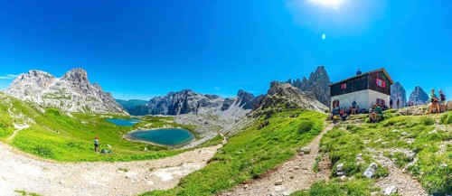 Tourists enjoying breathtaking views while hiking near the tre cime di lavaredo peaks and mountain