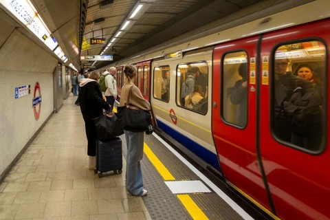 Crowded underground tube train arriving at station platform, Kings Cross Station, London, England,