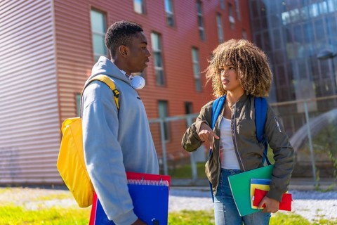 Latin beauty young woman talking to university colleague outside the university