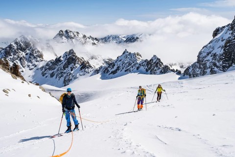 Ski tourer with rope, rope team on the Vadret da Porchabella glacier on the ascent to the summit of