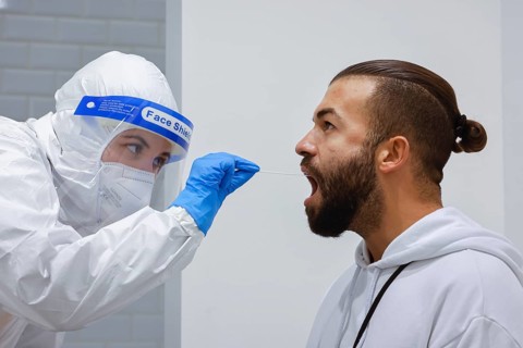 Cologne, North Rhine-Westphalia, Germany - Covid rapid test at the Medicare test centre, throat