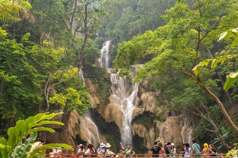 Tourists on the bridge at Kuang Si waterfall near Luang Prabang, Laos, Asia
